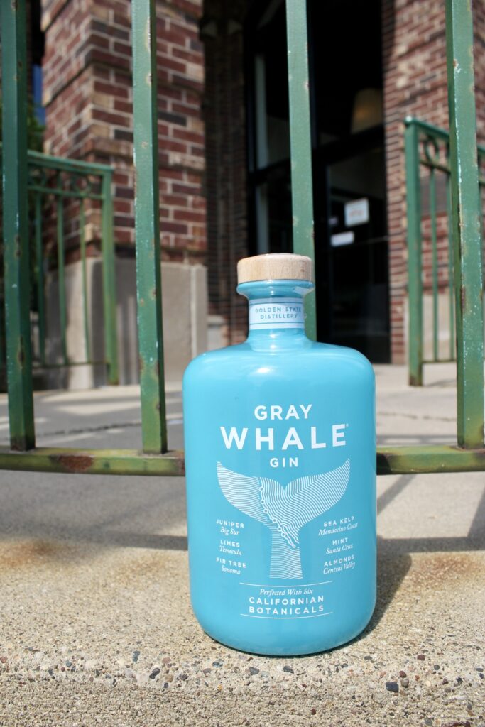 bottle of gray whale gin on sidewalk