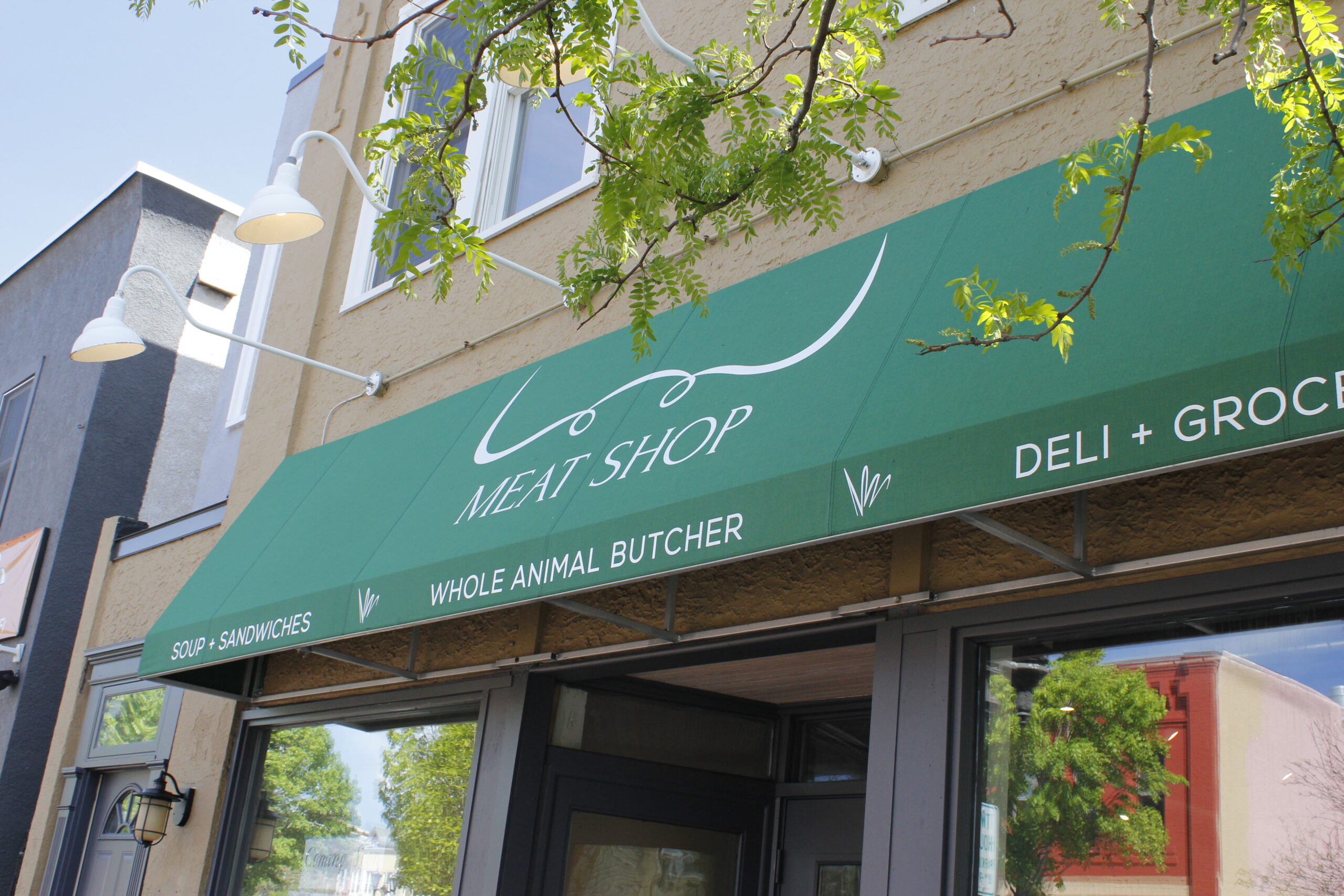 storefront with green awning that reads St Paul Meat Shop