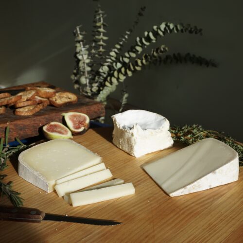 Three cheeses on a wooden board