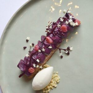 Purple plated pastry with ice cream