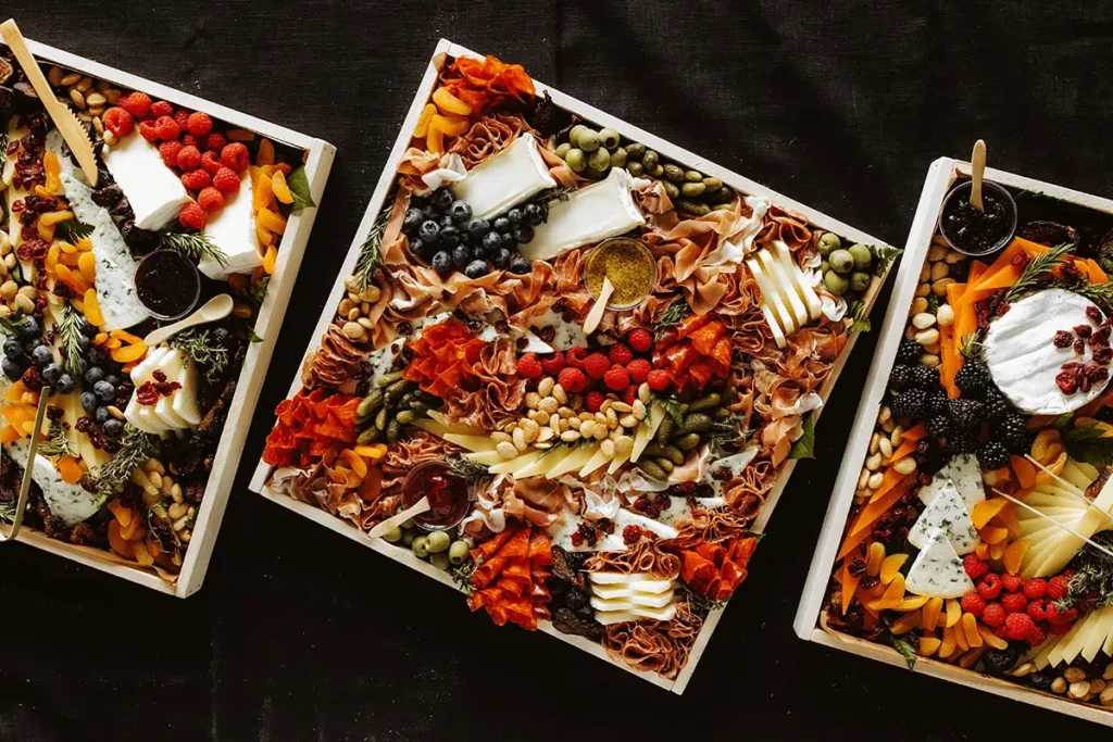multiple full charcuterie boards on a table