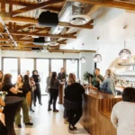 a lively space with people drinking cocktails