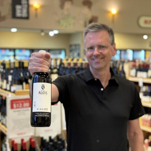 Rick holding a bottle of Michele Alois wine