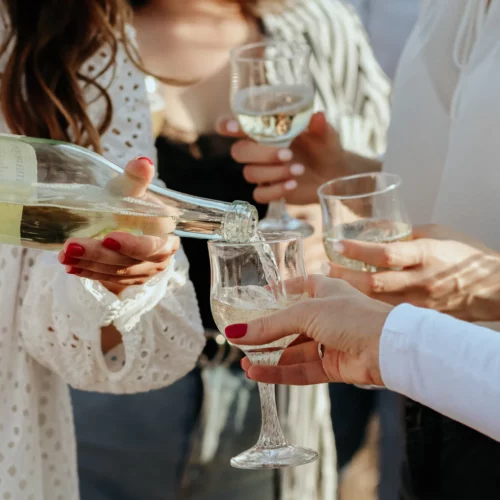 Pouring glasses of white wine
