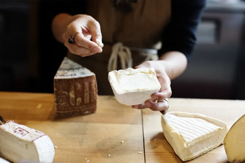 employee cutting cheeses