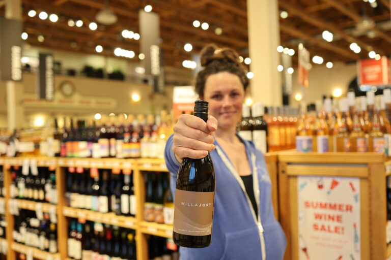 Emily holding a bottle of Willajory Pinot Noir