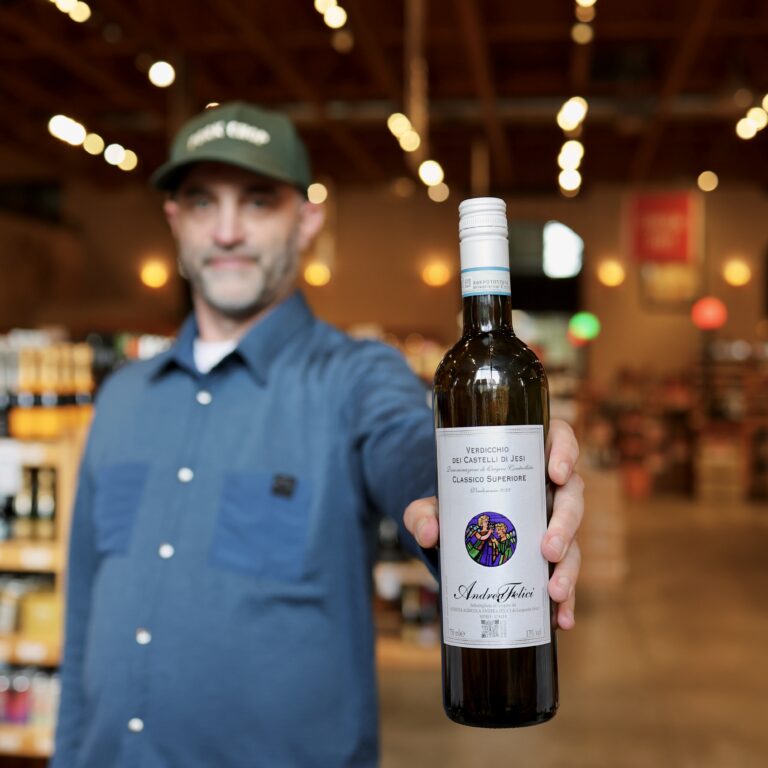 Benjamin holding up a bottle of Andrea Felici Verdicchio dei Castelli di Jesi