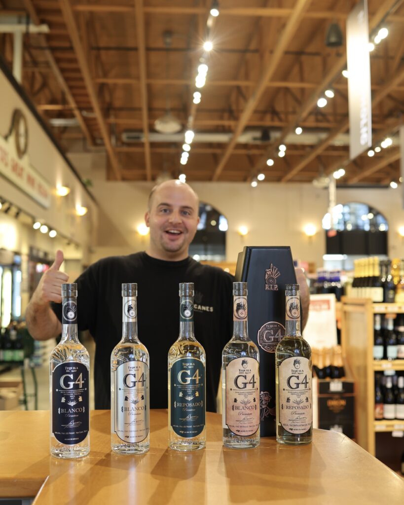 Chris posing in the store with all the G4 bottles