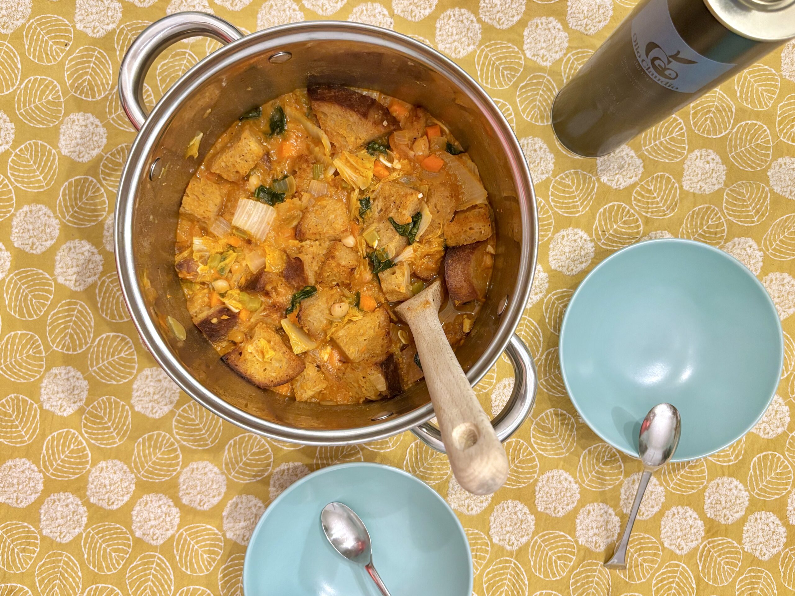 Pot of ribollita on a yellow tablecloth