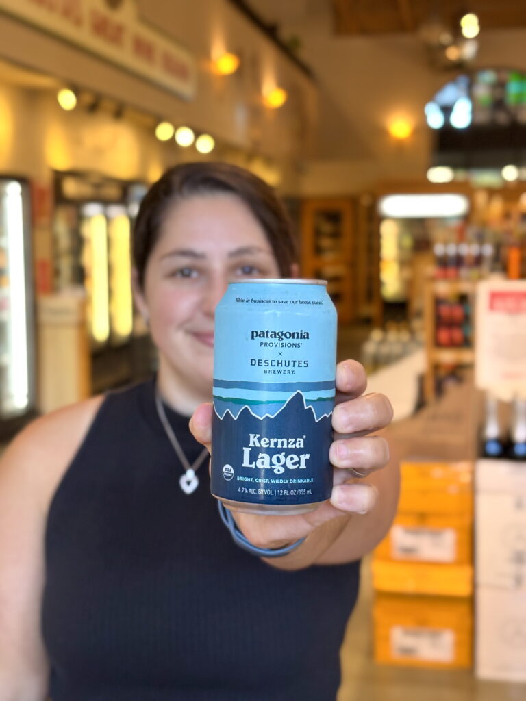Anna holding up a can of Kernza® Lager by Deschutes Brewing