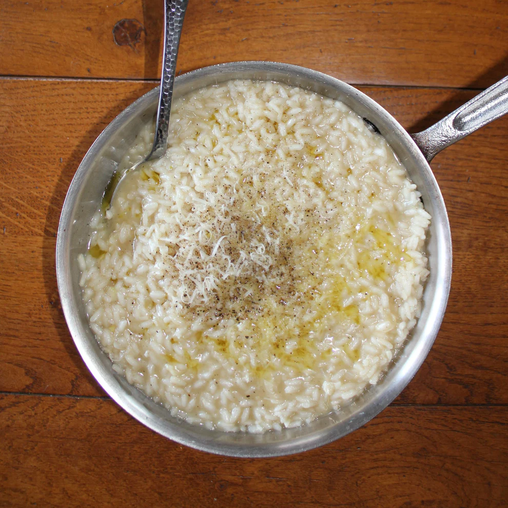 Pan of risotto on a wooden table
