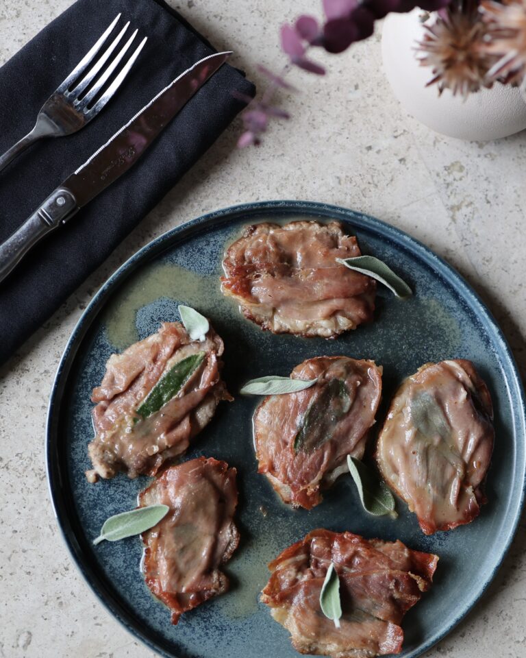 Veal saltimbocca on a blue ceramic plate