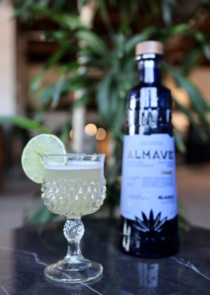 Margarita & blue bottle of Almave N/A tequila