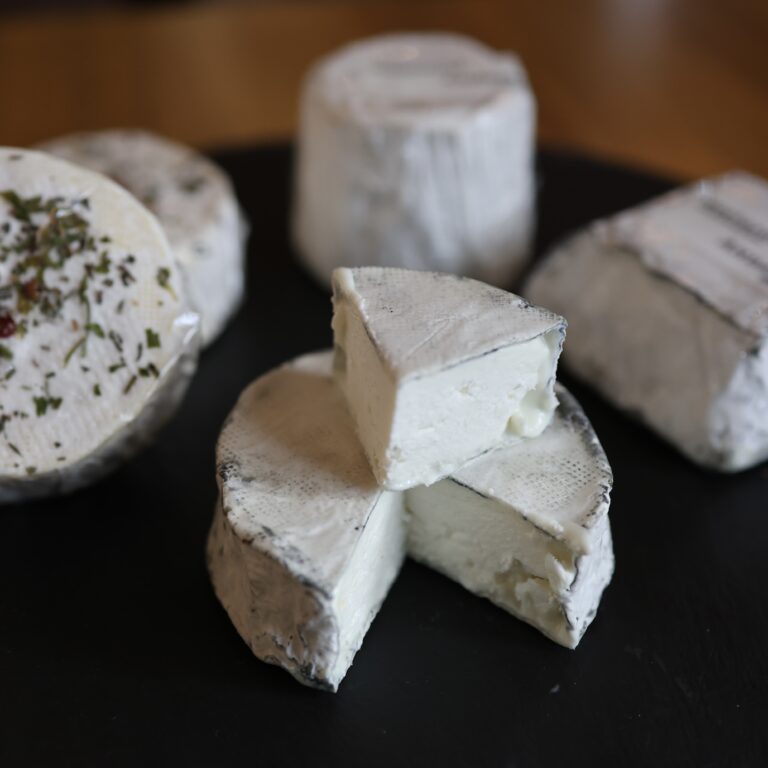 Acapella cheese on a black slate surrounded by other Andante cheeses