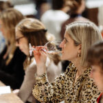 Person drinking wine at a tasting