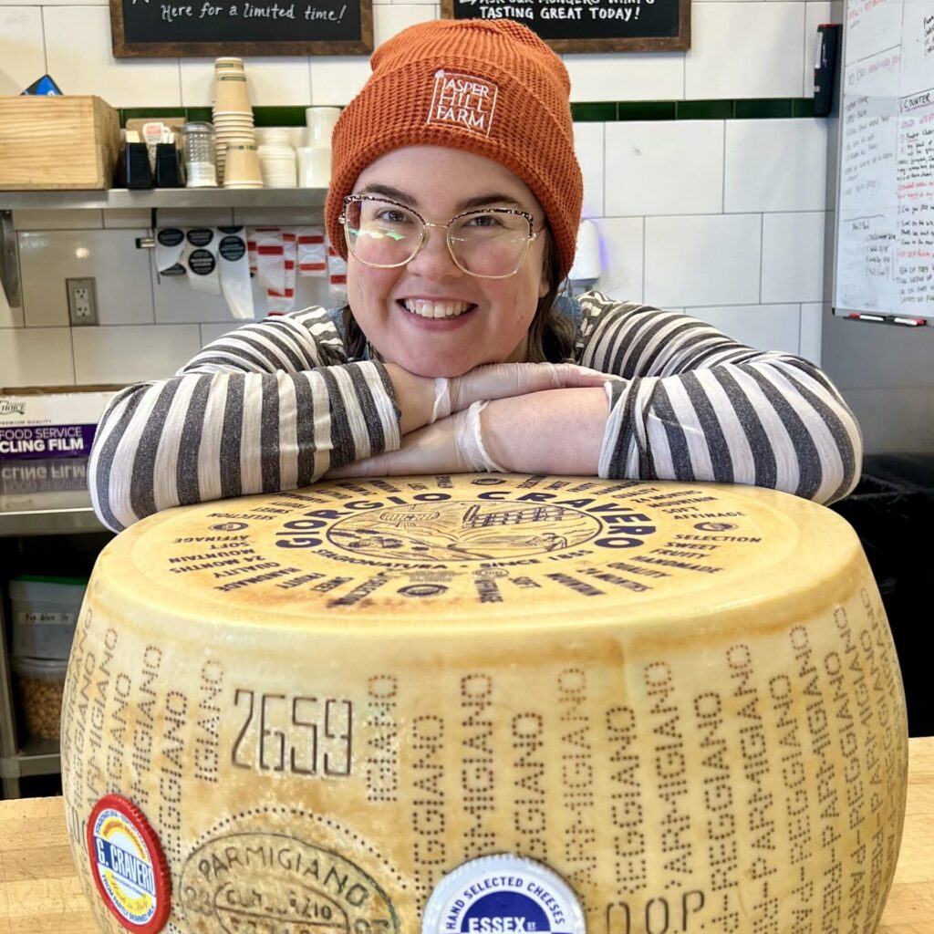 Michelle leaning over a wheel of Cravero Parmigiano Reggiano