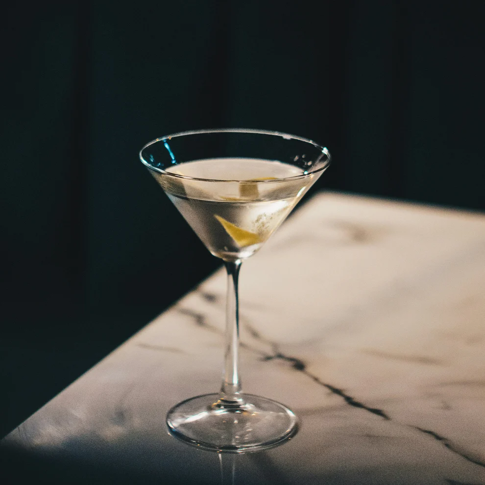 Martini sitting on a table with a dark black background