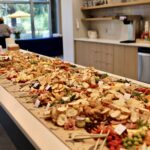 Large 100 person grazing table on a white counter