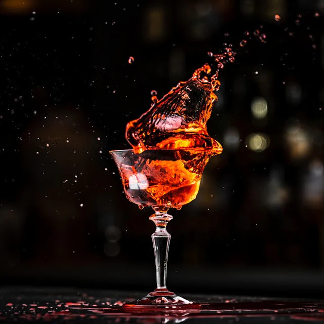 Vermouth in a glass in front of a black background