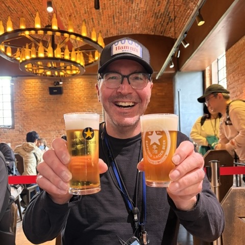 Bill holding two glasses of beer