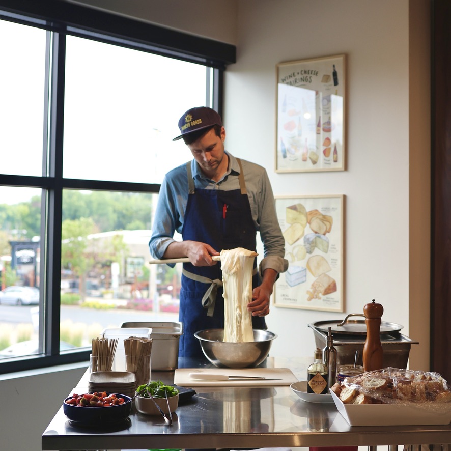 Austin pulling mozzarella in the corner of the event space