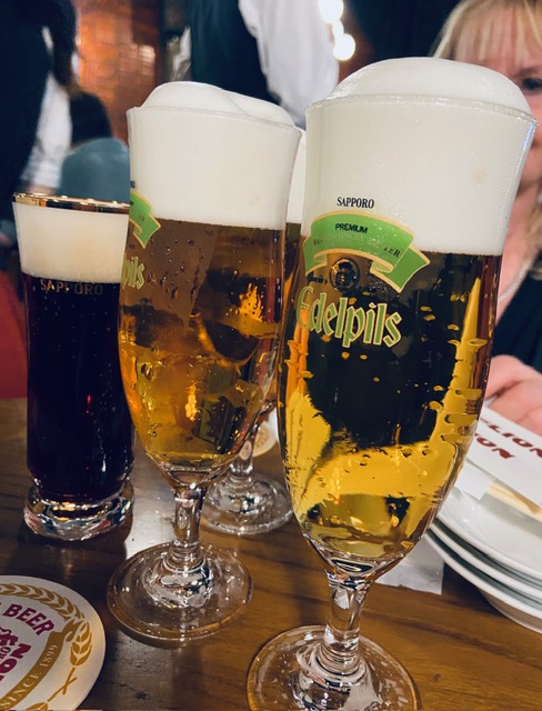 Two glasses of beer on a wooden table
