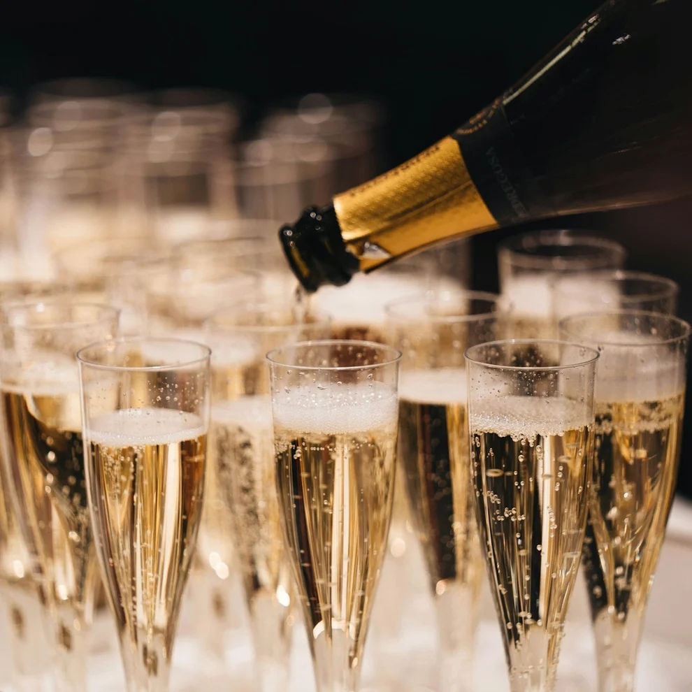 Pouring champagne into 12 flutes