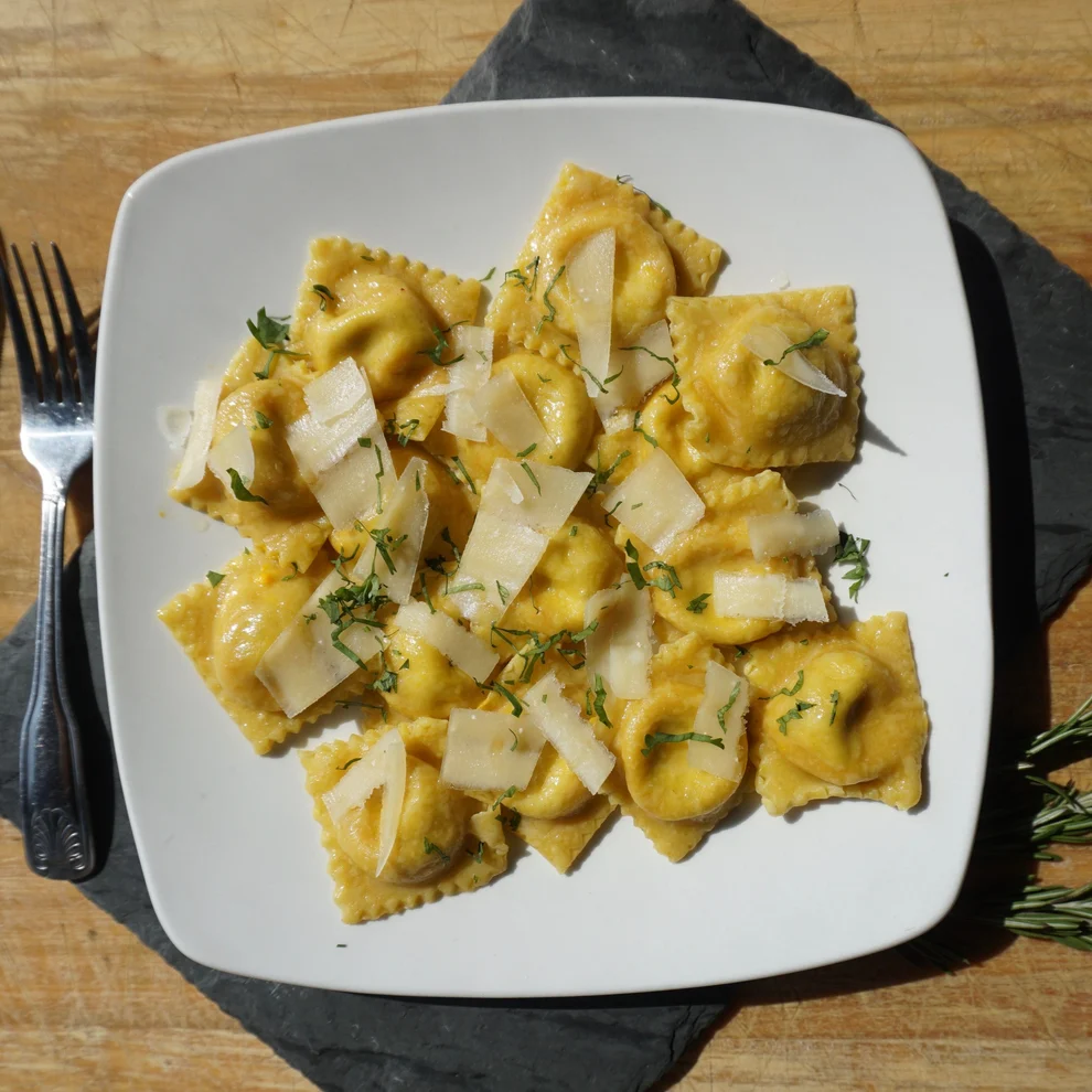 Plate of ravioli topped with parm