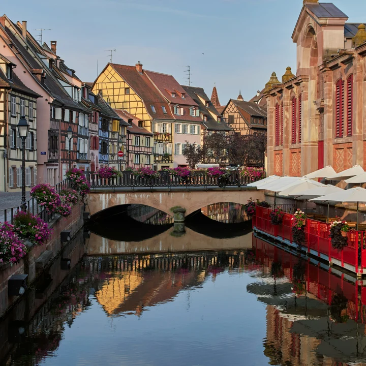 Colorful houses lining a river in Alsace