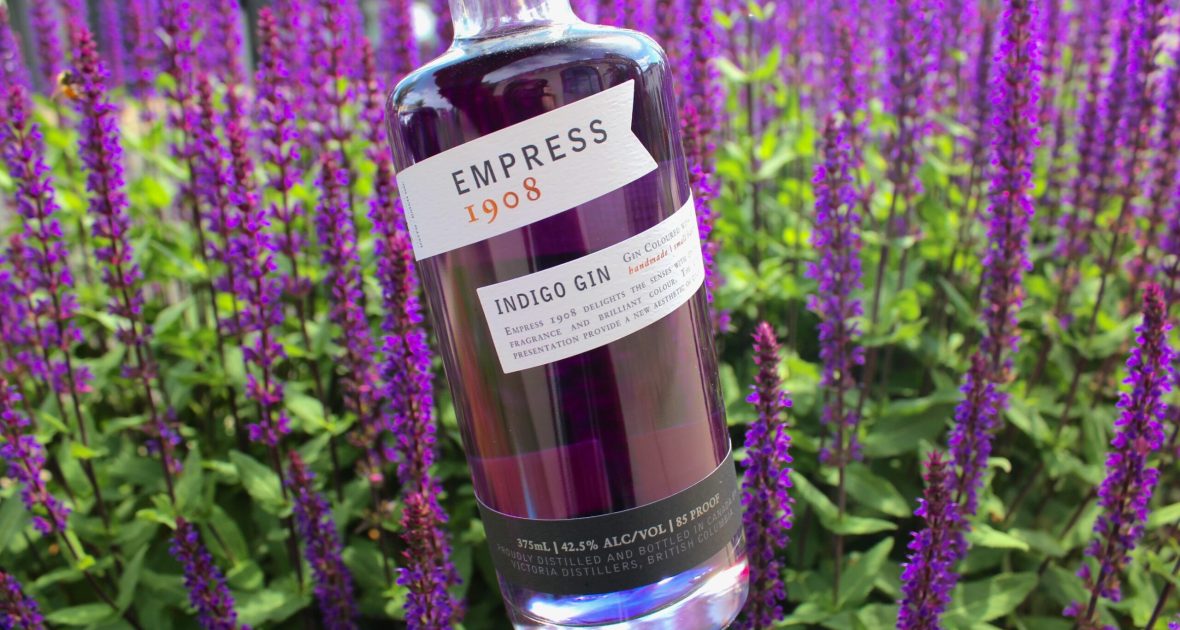 bottle of empress gin in front of purple flowers